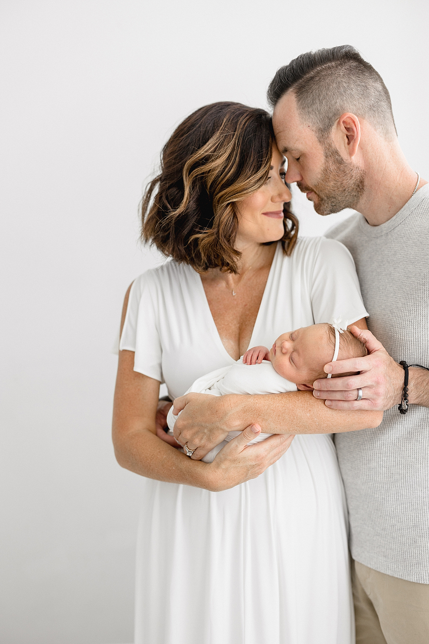 Mom and Dad with baby girl. Photo by Brittany Elise Photography.