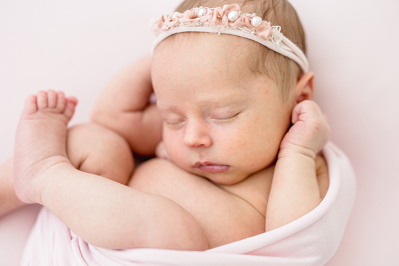 Baby girl curled up for newborn photos. Photo by Brittany Elise Photography and blog post on being intentional.