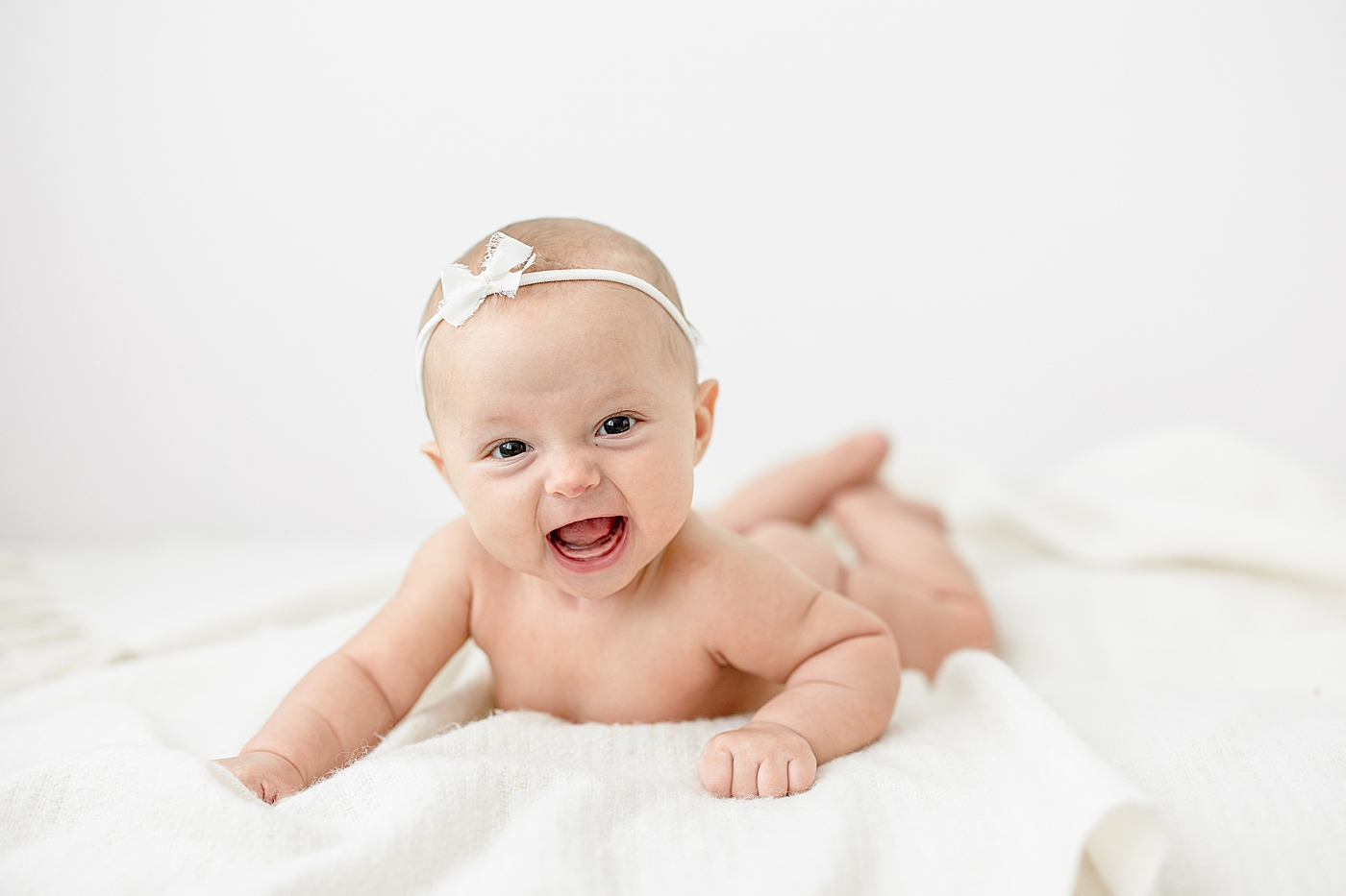 Milestone photos of three month old baby girl in studio. Photo by Brittany Elise Photography.