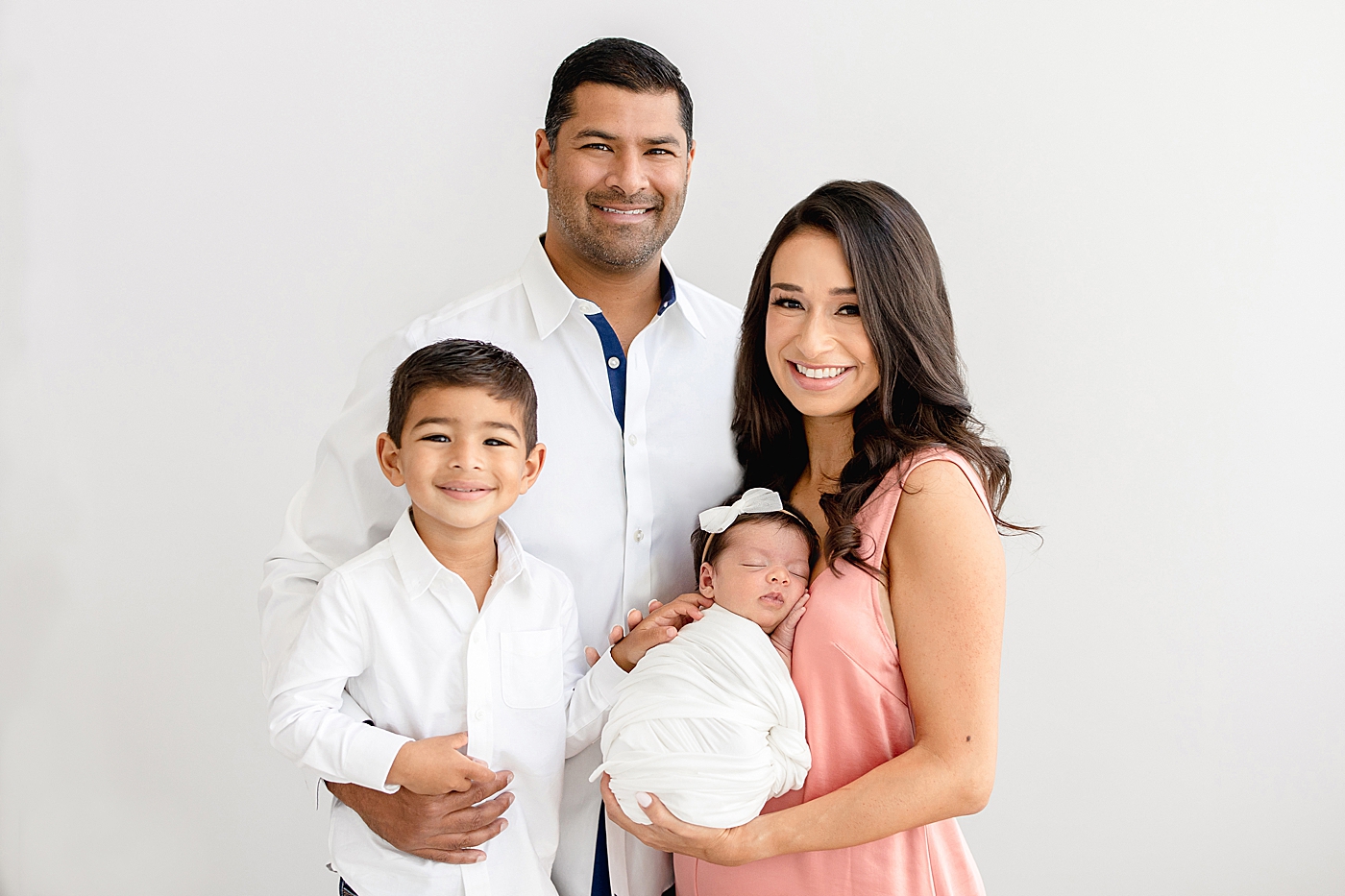 Family of four newborn session in studio in Tampa. Photo by Brittany Elise Photography.