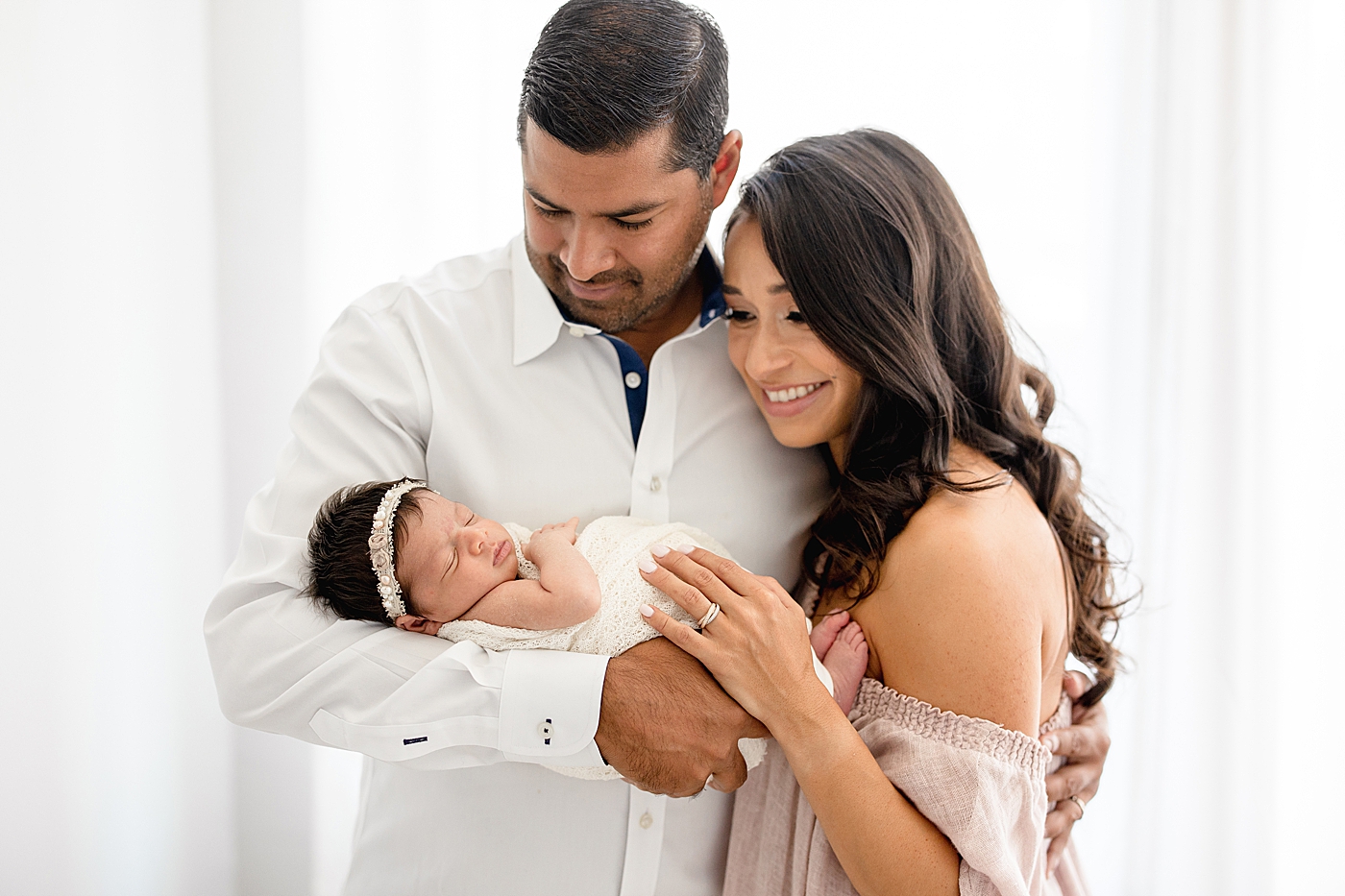 Mom and Dad with their baby girl. Photo by Brittany Elise Photography.
