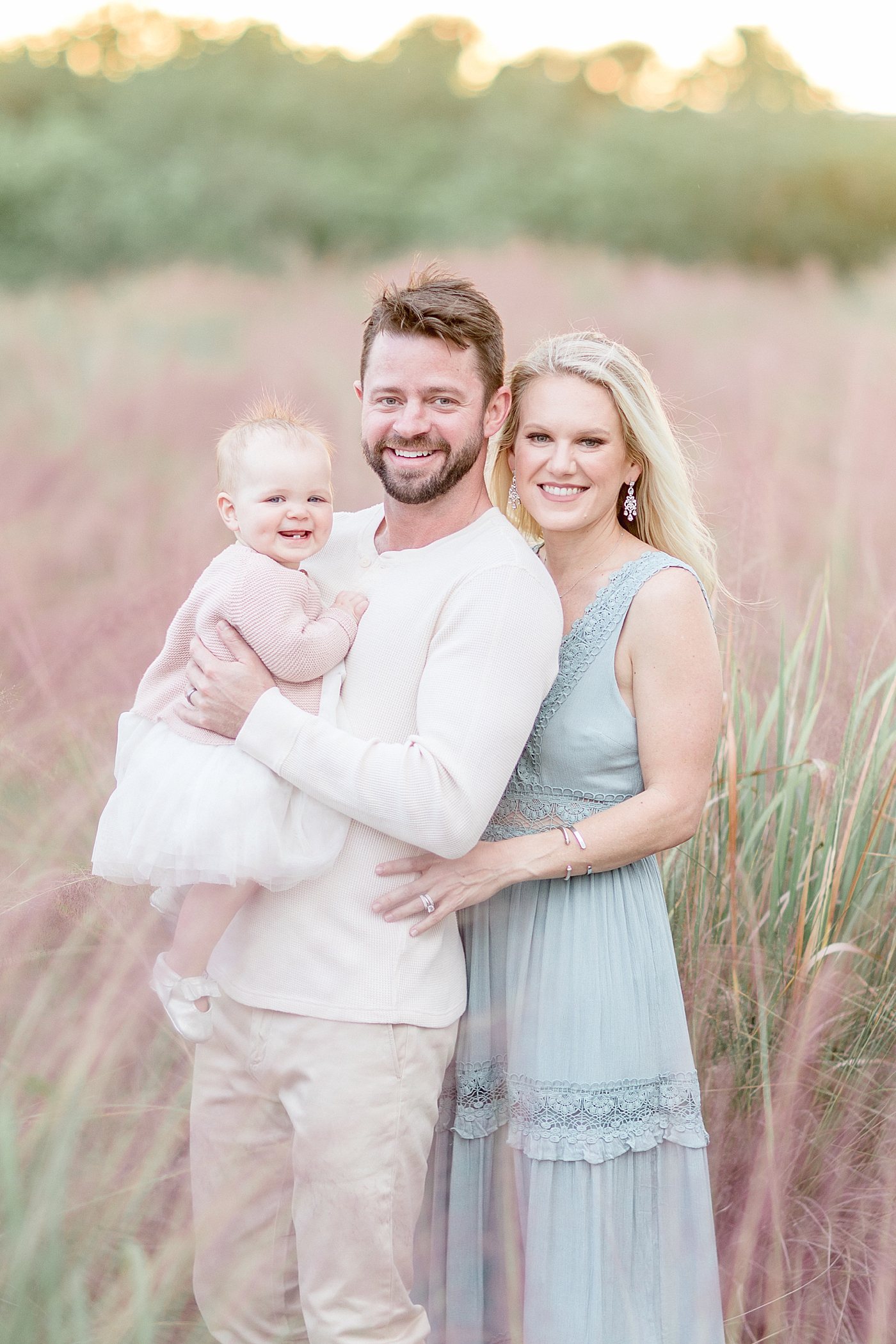 Mom and Dad with their one year old daughter. Photo by Brittany Elise Photography.