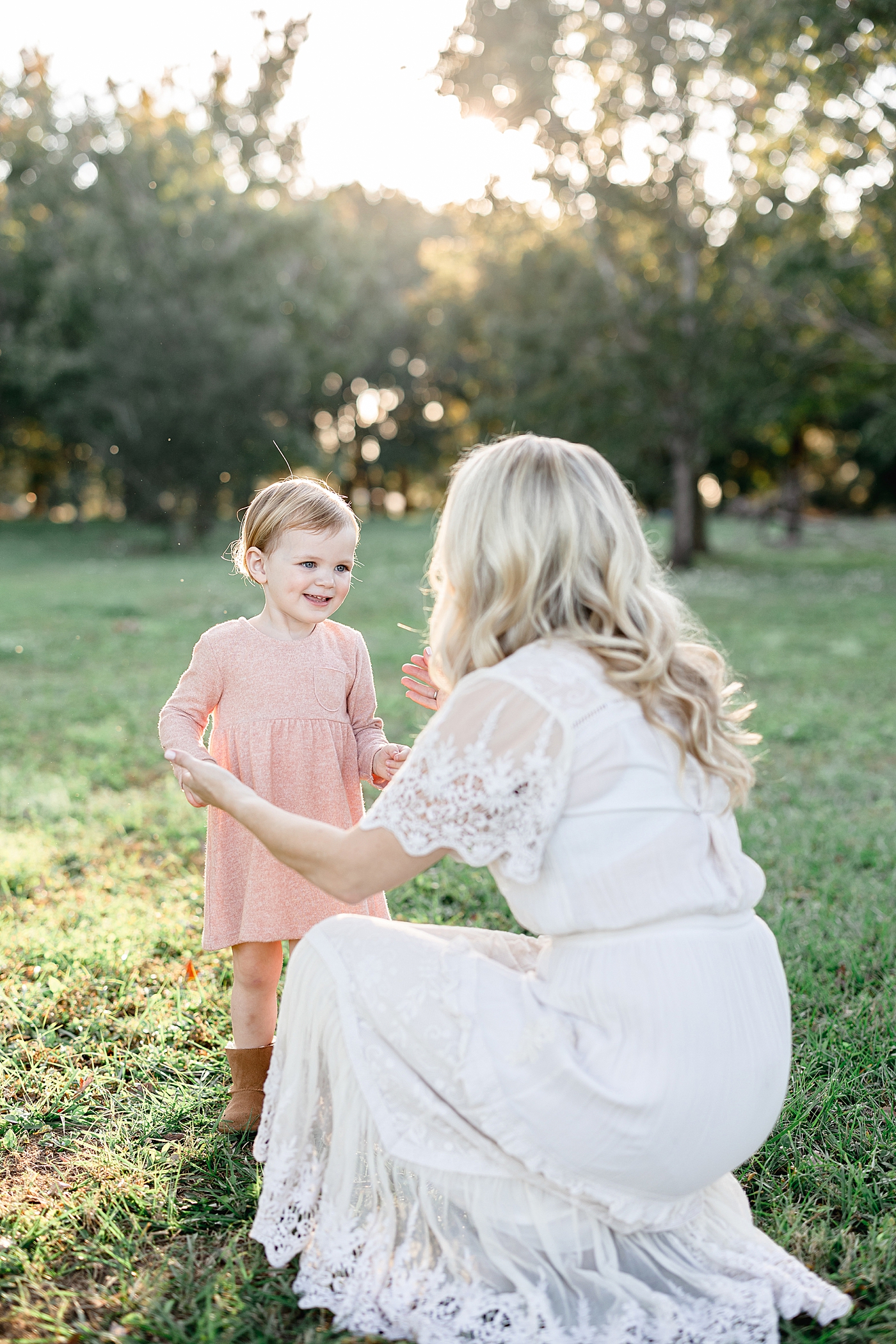 Mom bending down looking at her little girl. Photo by Brittany Elise Photography.