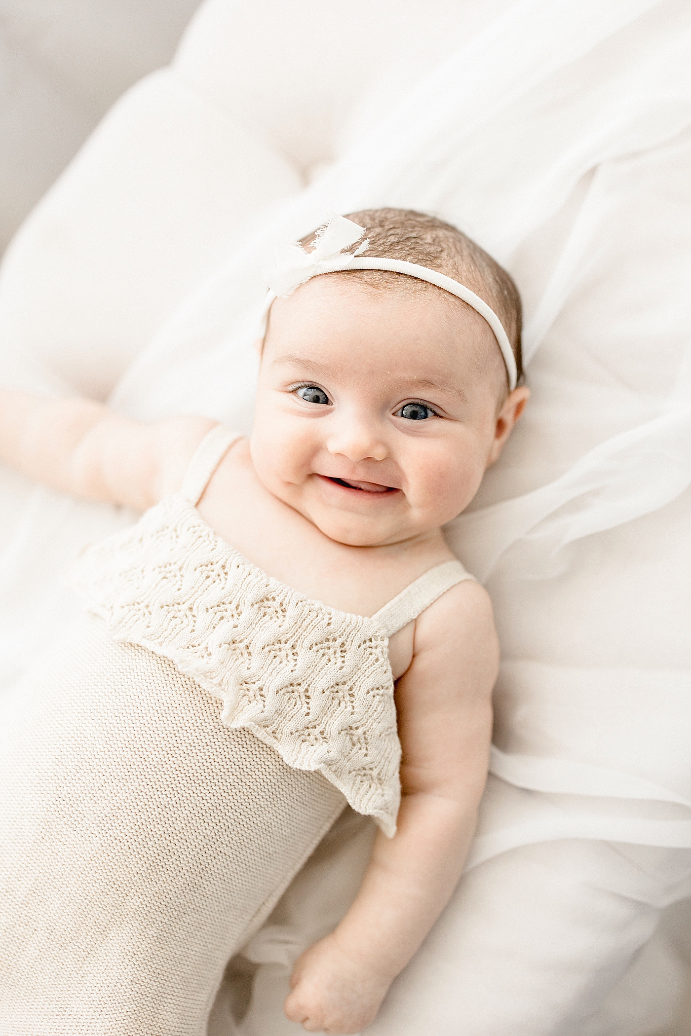 3 month old baby girl smiling for photos with Brittany Elise Photography.