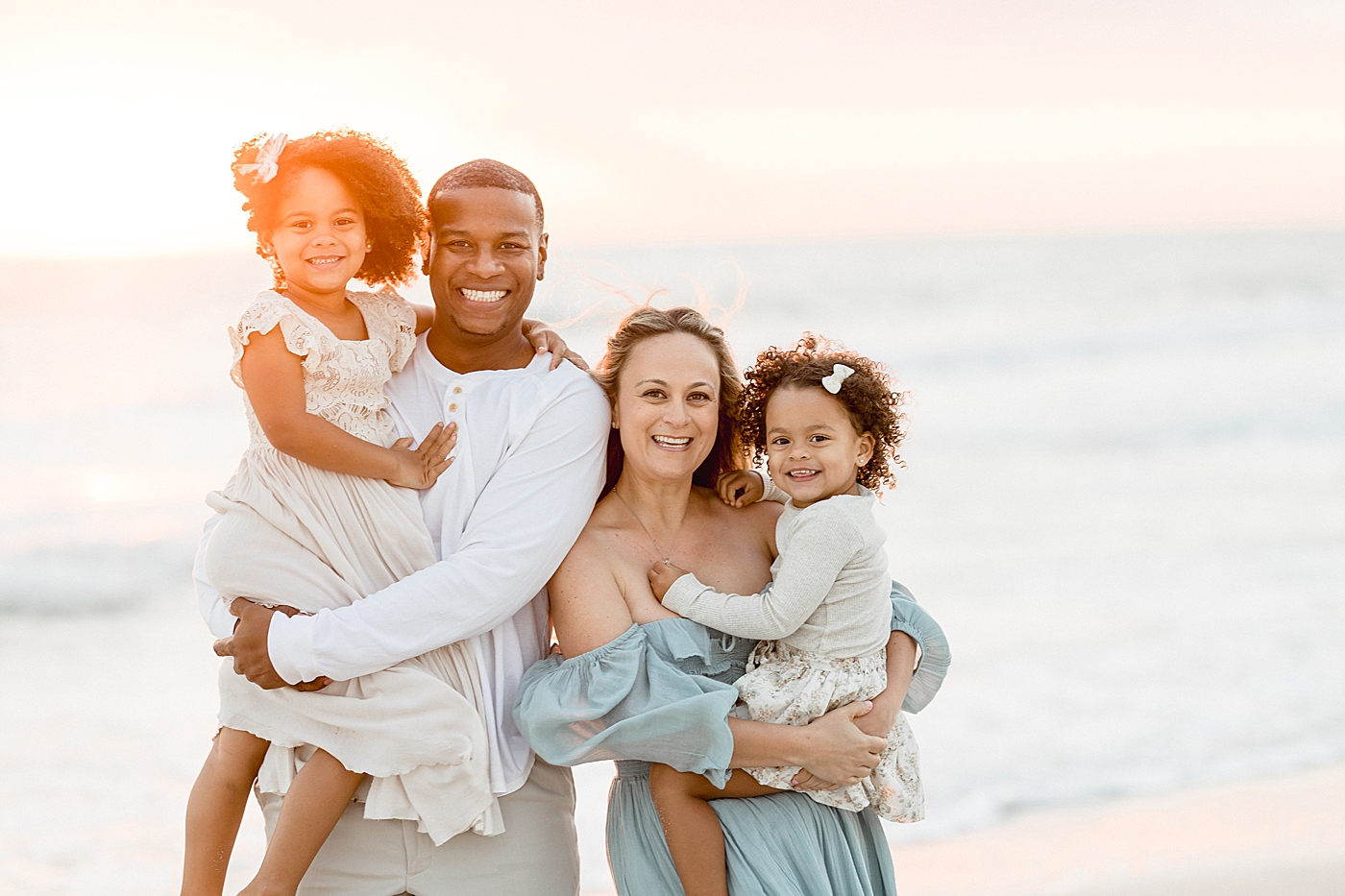 Sunset beach session for family of four in Tampa. Photo by Brittany Elise Photography.