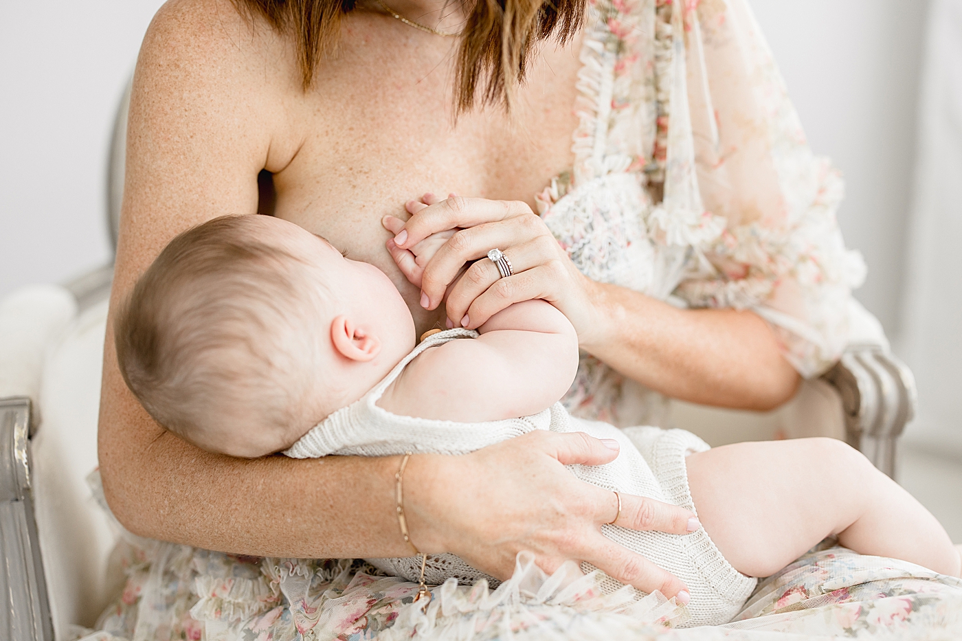 Mom breastfeeding her six month old daughter. Photo by Brittany Elise Photography.