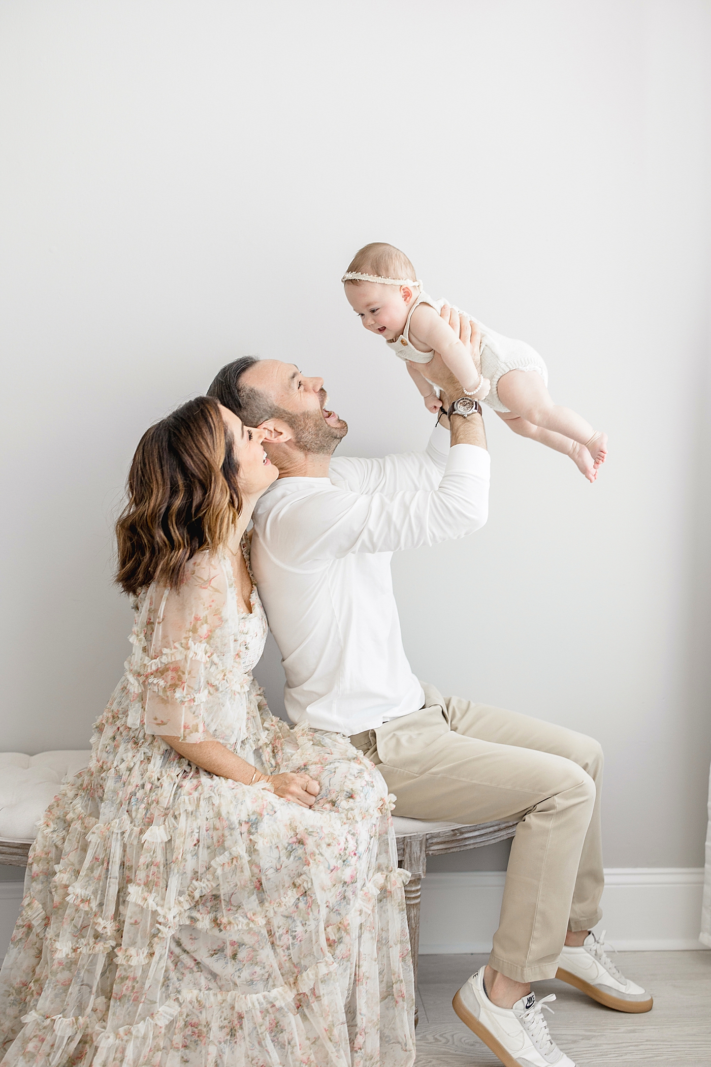 Mom and Dad playing with their six month old daughter. Photo by Brittany Elise Photography.