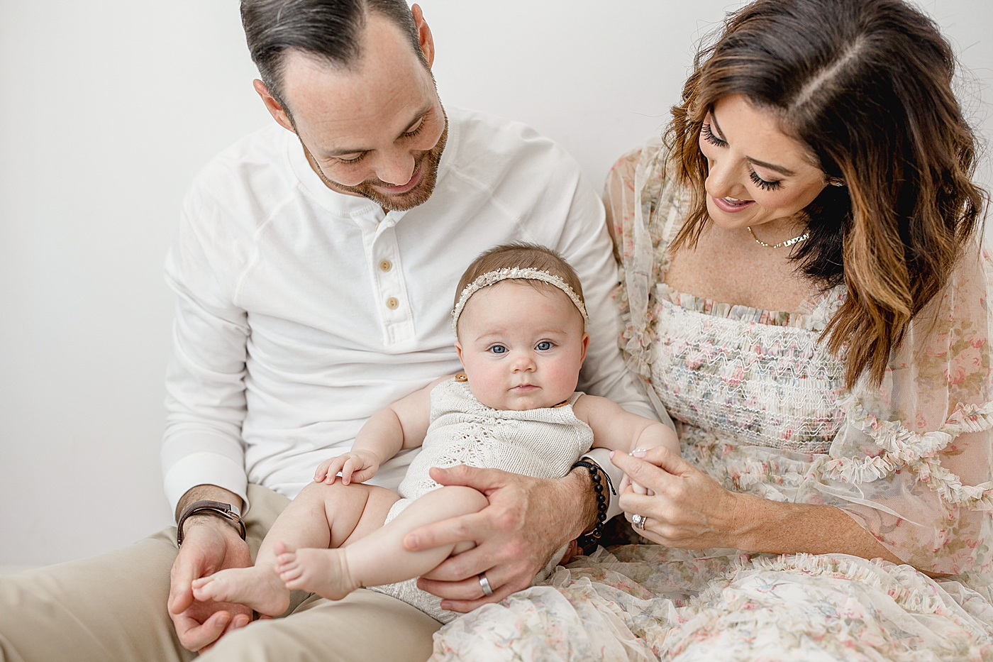 Family portraits of parents and baby girl during six month milestone session. Photo by Brittany Elise Photography.