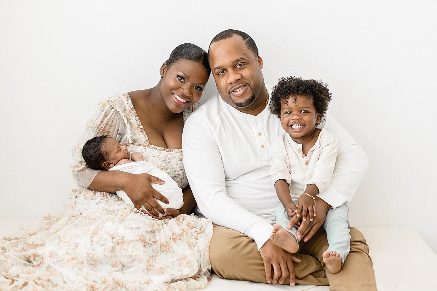 Family portrait of parents with two boys. Photo by Brittany Elise Photography.