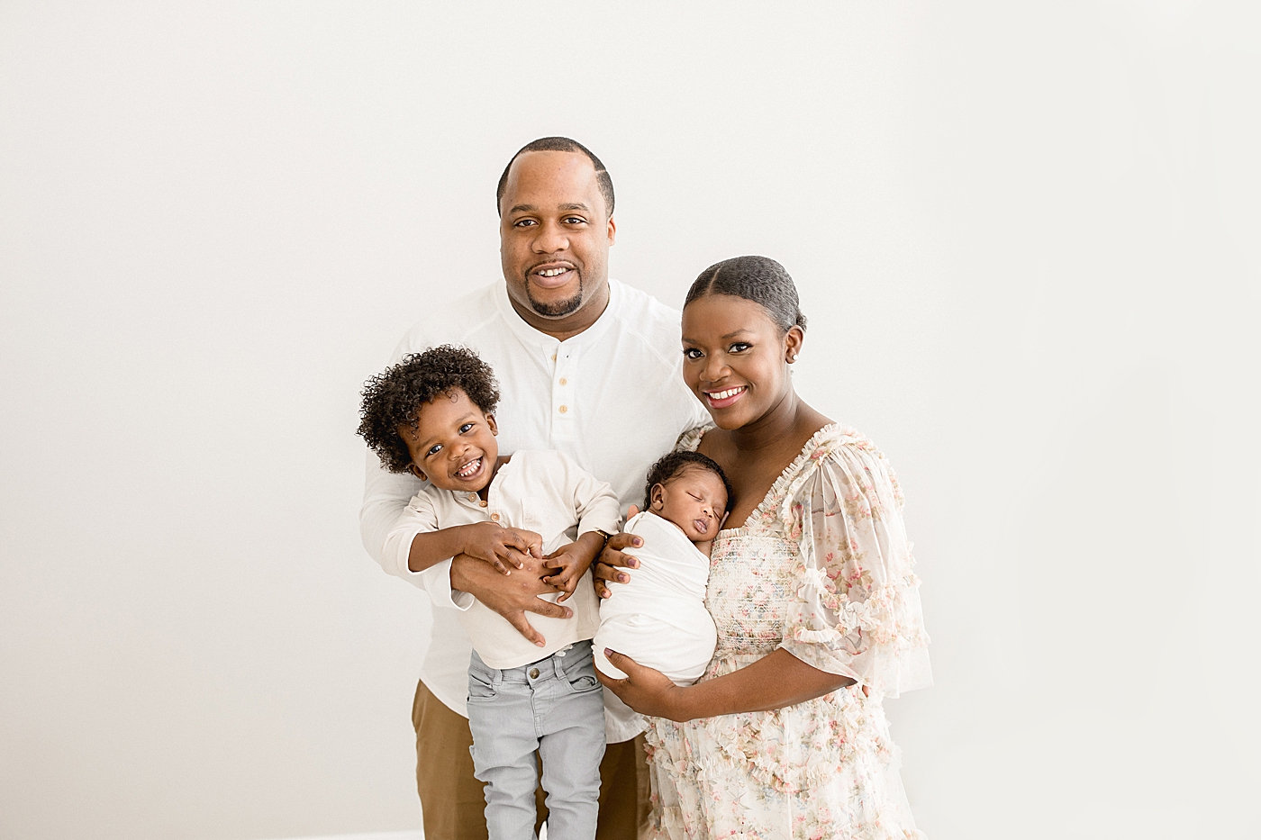 Family of four in studio in Tampa for newborn session. Photo by Brittany Elise Photography.